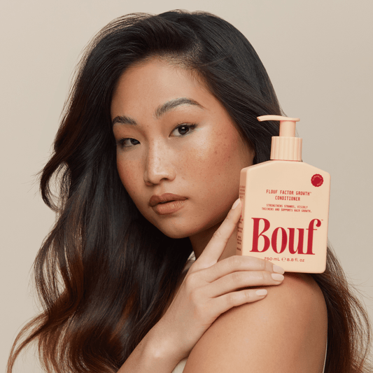 Woman holding Bouf Conditioner 250mL Flouf Factor Growth™ Conditioner