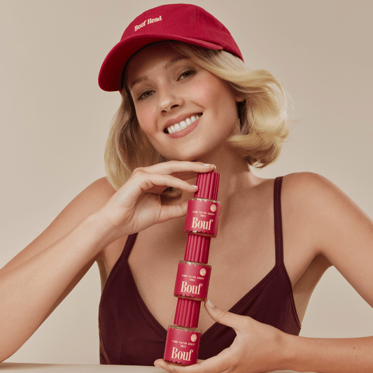 Woman posing with Tonics wearing a hat.
