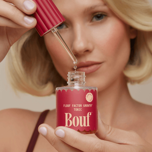 Woman posing with Bouf Tonic 50mL Flouf Factor Growth™ Tonic