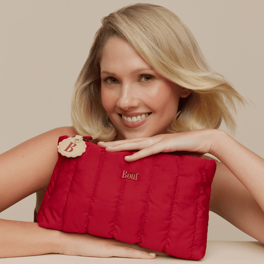 Woman posing with Bouf Travel pack.